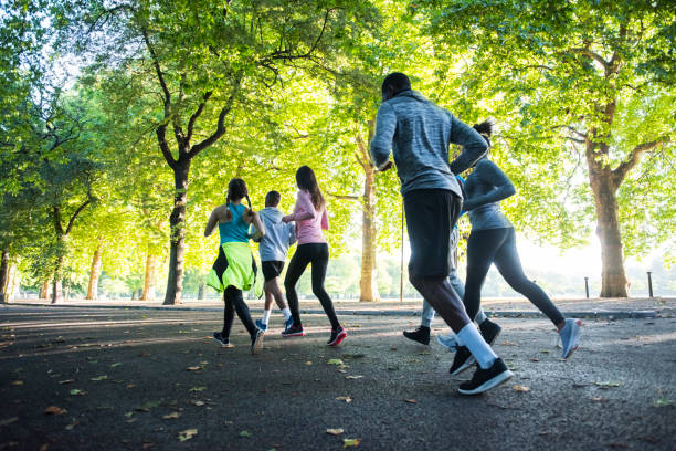 istock Happy young friends running together 862334994
