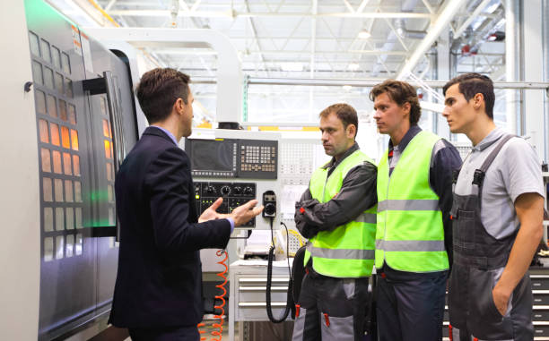 istock Manager and workers near CNC machines 862337916