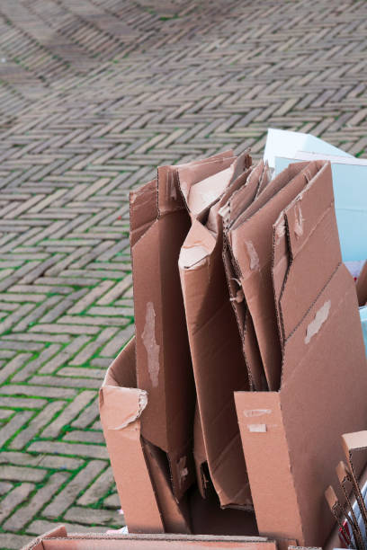 istock recycling old paper, carton box, packaging on brick street 862337942