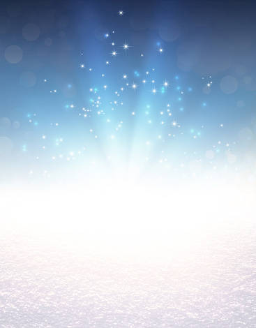Blue colored light explosion and glittering stars on a snow covered ground