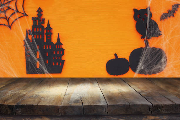 istock Halloween holiday concept with empty rustic table over orange background. Ready for product display montage 862350428