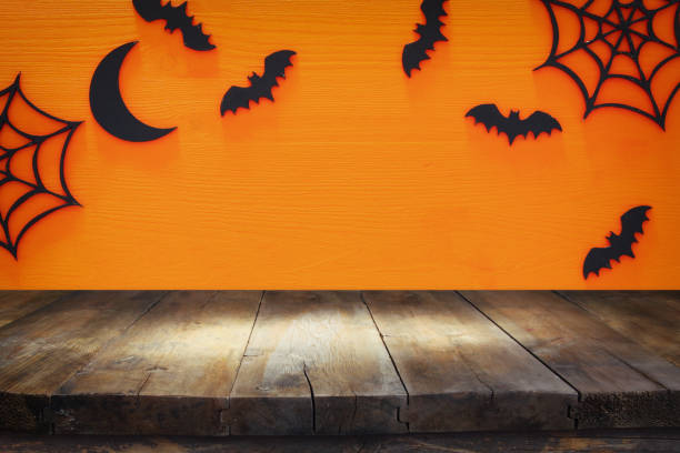 istock Halloween holiday concept with empty rustic table over orange background. Ready for product display montage 862350458