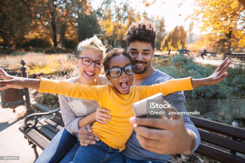 Picture of happy young couple spending time with their daughter Happy young mixed race couple spending time with their daughter Family Stock Photo