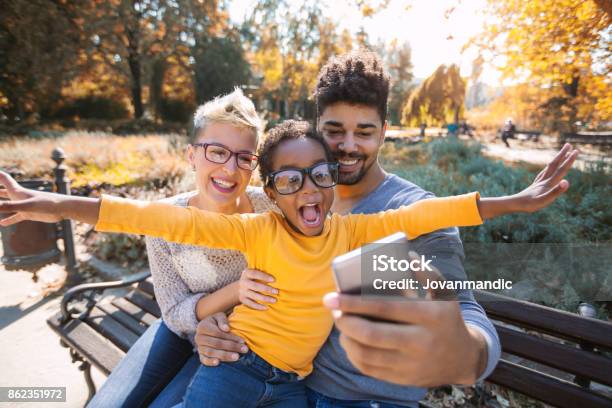 Picture Of Happy Young Couple Spending Time With Their Daughter Stock Photo - Download Image Now