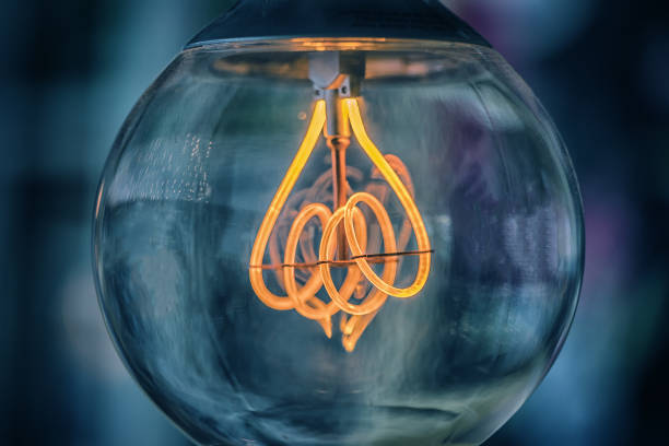 istock Old edison light bulb glowing in the dark 862354514