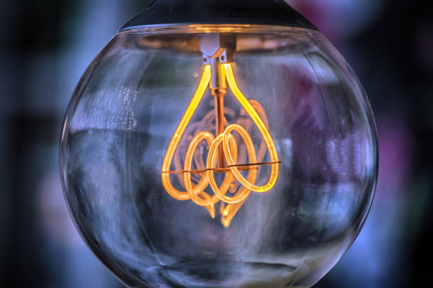 istock Old edison light bulb glowing in the dark 862354606