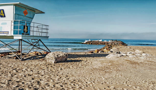 Buena Ventura City Park Lifeguard Station and Log on Rocks stock photo