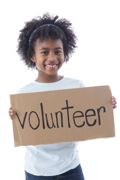 istock Adorable elementary age girl holding a volunteer sign 862362444