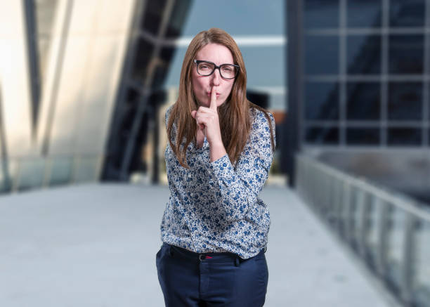 istock Pretty  young business woman making silence gesture . 862366438