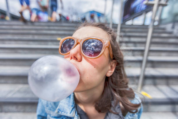 istock Woman portrait blowing a bubble chewing gum 862367080