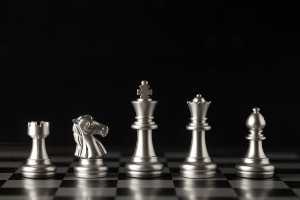 istock Chess on a chessboard at black background, Business leader concept. 862371444