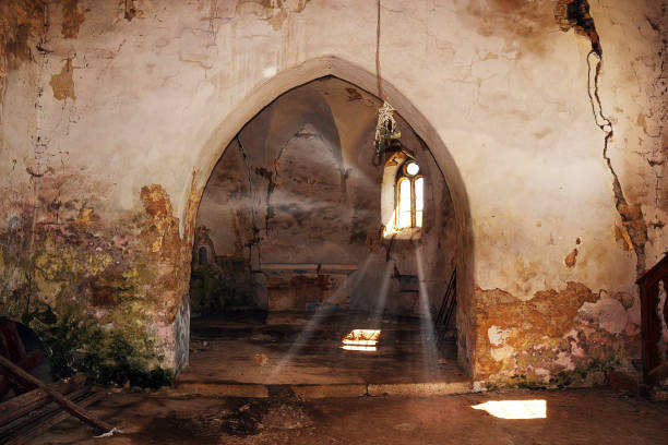 rays of light entering an abandoned damaged gothic church