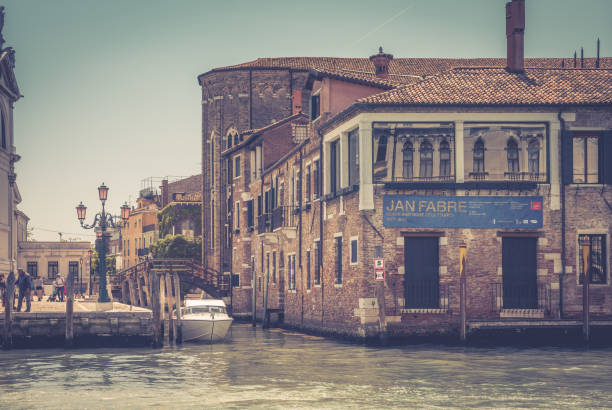 Venice, Italy - May 18, 2017: Traditional view of the street and the Grand Canal with old houses. The Grand Canal is the main street and tourist attraction in Venice.