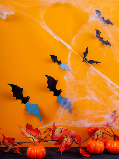 istock bat Halloween orange bright Vaughn, copy space, cute, humorous backdrop for a fun filled holiday, flat lay, black spiders and pumpkin. 862378894