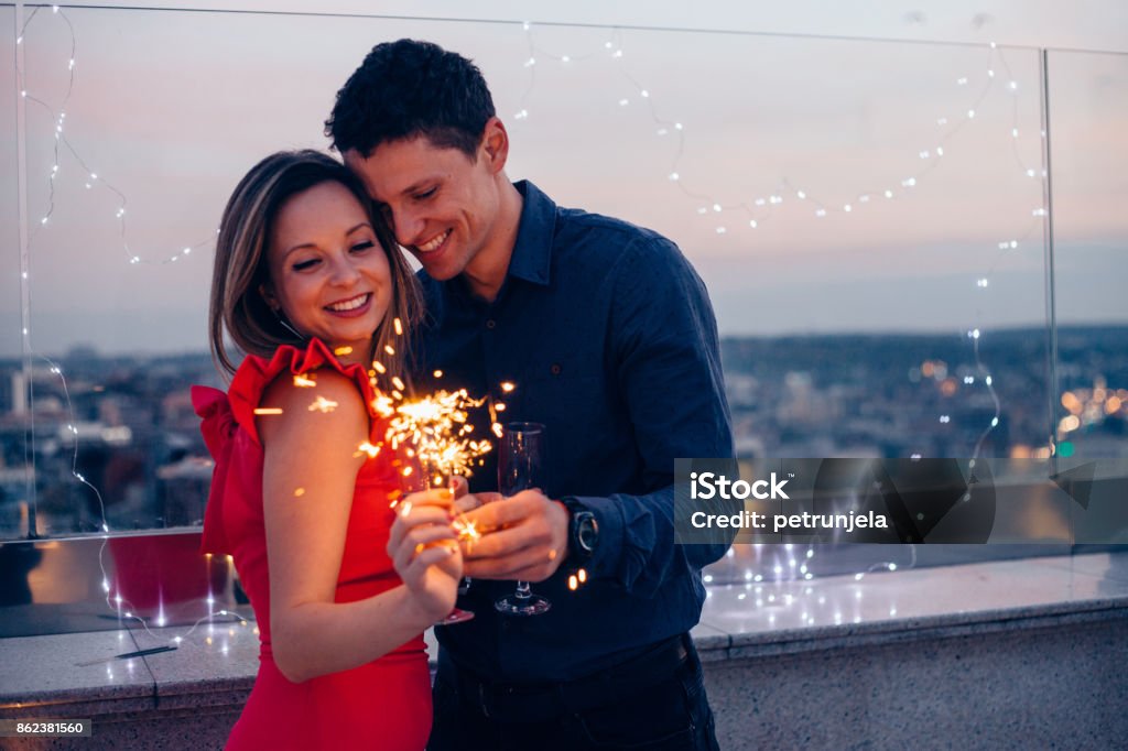 Love is in the air Couple celebrate New year on top of building. New Year Stock Photo