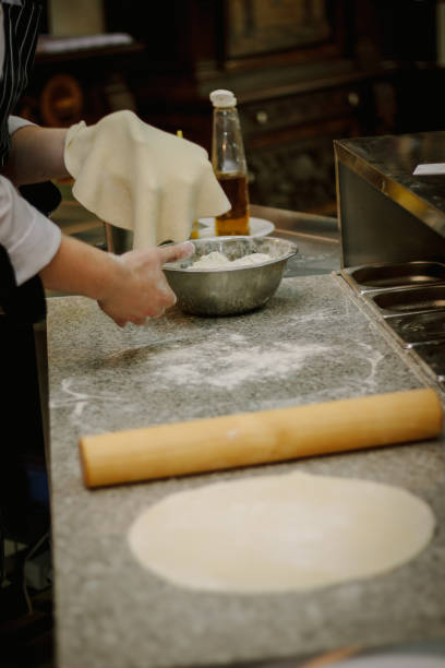 istock Chef preparing dough for pizza at italian pizzeria. 862381588