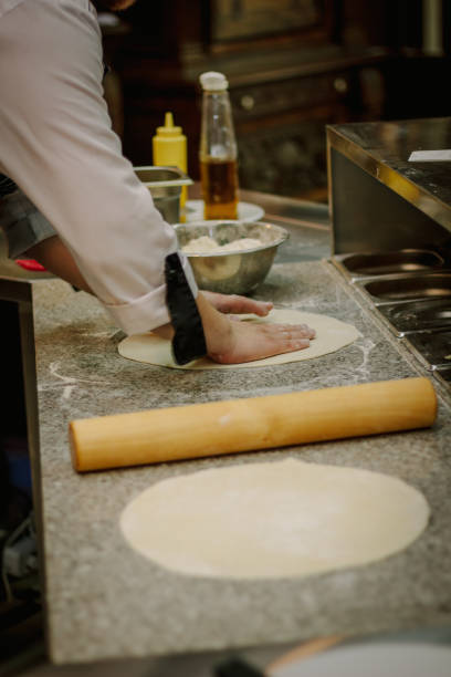 istock Chef preparing dough for pizza at italian pizzeria. 862381654