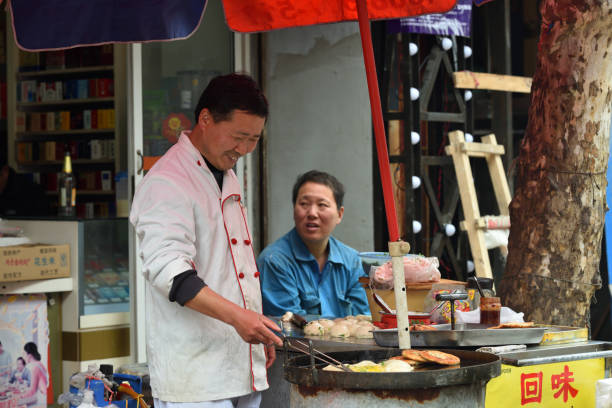 SHANGHAI, CHINA - MARCH 19: Unidentified Chinese people trades traditional food on March 19, 2016 in Shanghai, China. Shanghai is the largest Chinese city by population.