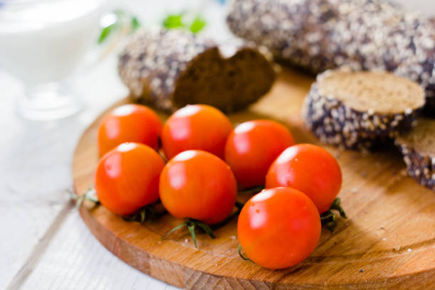 istock Bunch of cherry tomatoes over wooden board. 862387848