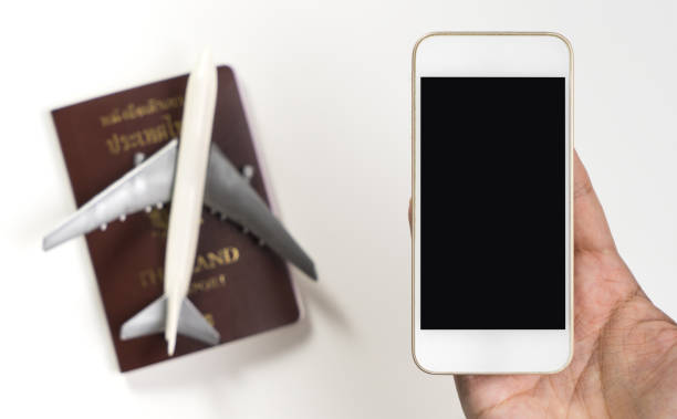 istock Hand holding empty phone screen with plane and passport for travel concept 862395978