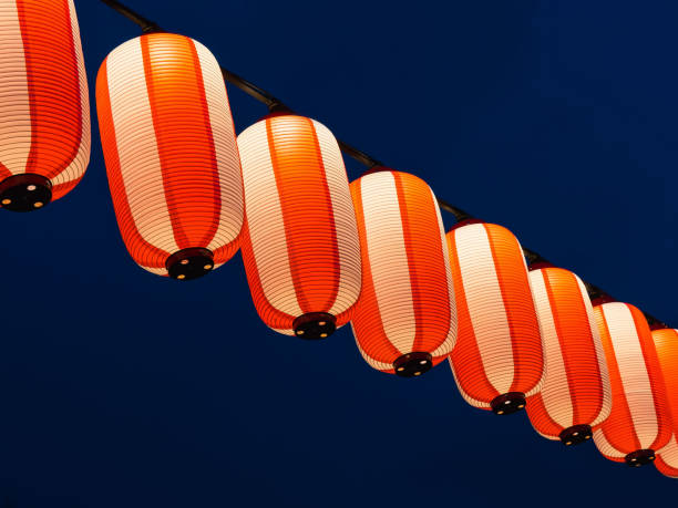 istock Paper red-white japanese lanterns Chochin shines on dark sky 862401124