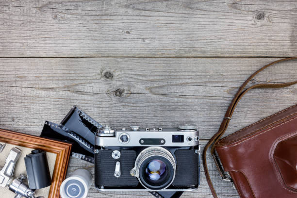 istock empty photo frame, old camera with leather case and negative films on wooden table 862401634