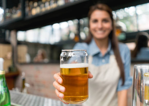 Waitress serving beer at a bar
