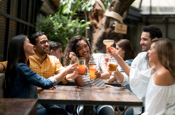 istock Happy group of people making a toast at a restaurant 862404204