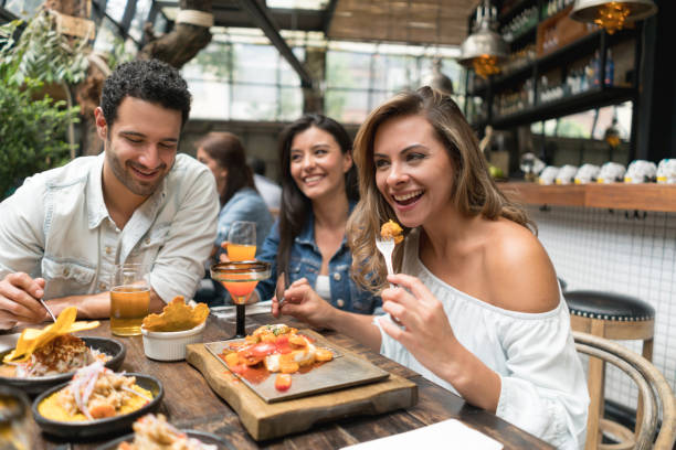 istock Woman having dinner with a group of friends 862404482