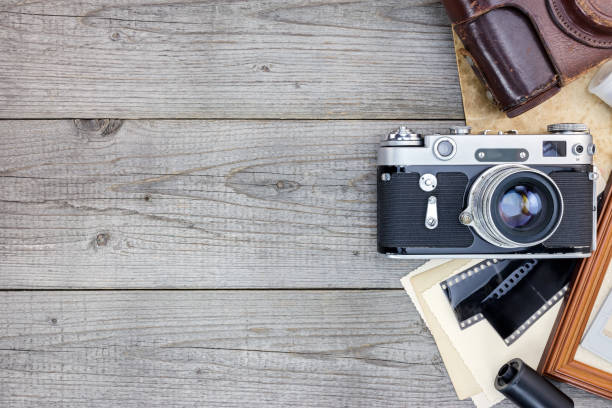 istock retro camera, negative films and photo frame on old wooden boards 862404820