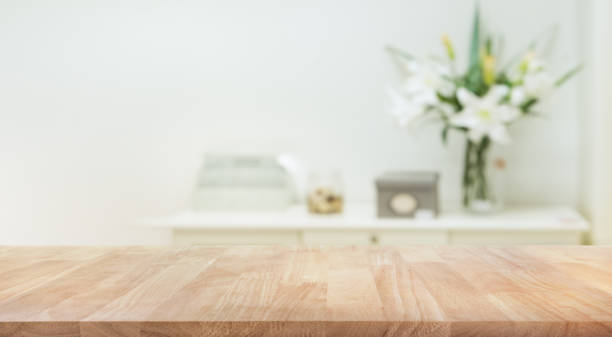 Real wood table top texture on white wall room background.