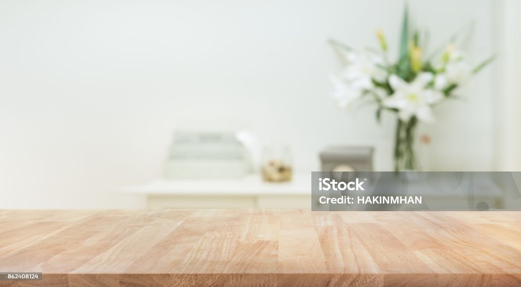 Real wood table top texture on white wall room background. Real wood table top texture on white wall room background.For create product display or design key visual layout Table Stock Photo