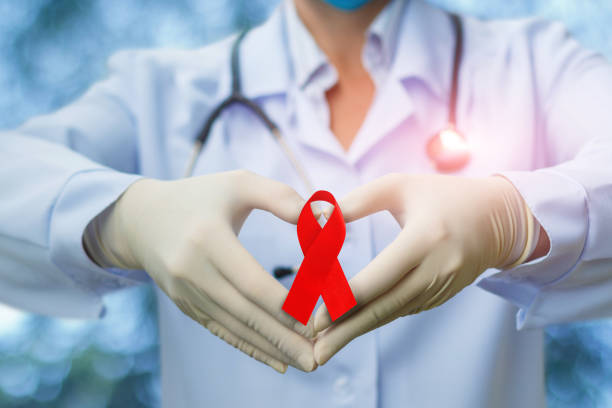 aids kırmızı kurdele eller bir doktor - world aids day stok fotoğraflar ve resimler