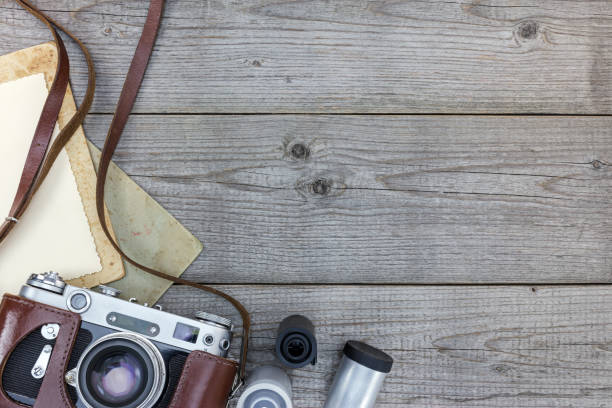 istock retro still camera and empty instant paper on wooden background top view 862412352