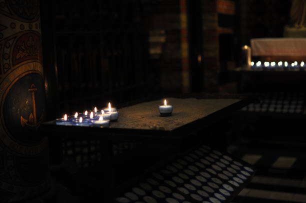 Table of lit intention tealight candles in a Catholic church in the Netherlands.