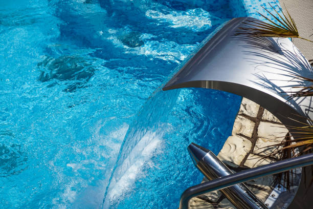 istock Swimming pool with fountain at hotel close up 862412552