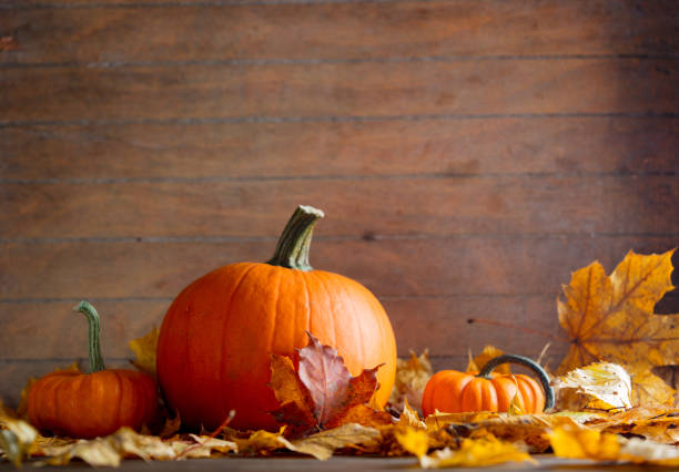 istock maple leaves and pumpkins on wooden table 862415604