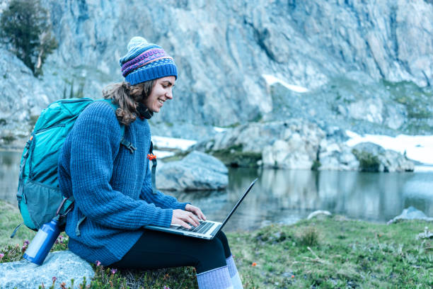 istock Woman using laptop in the wild 862415640