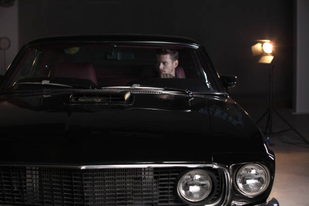 istock Young handsome  man drive classic car 862415832