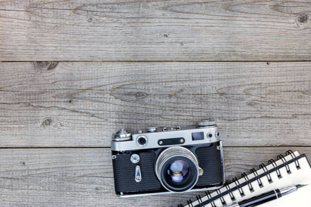 istock retro camera, notebook and pen on gray wooden table 862418588