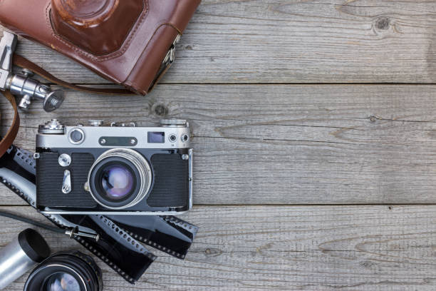 istock old camera with leather case, negative films and lenses on wooden desk 862419674