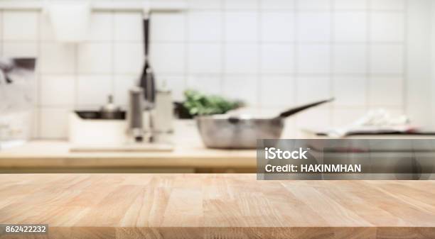 Wood Table Top On Blur Kitchen Room Interior Background Stock Photo - Download Image Now