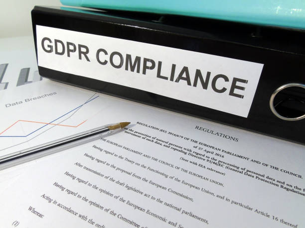 istock General Data Protection Regulation (GDPR) Compliance Lever Arch Folder on Desk with Documents (Legislative Text and Graphs) and Pen 862422314
