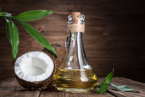 coconut and oil on a wooden background