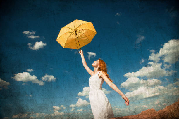 istock Redhead girl holding umbrella 862422662