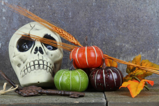 istock An Autumn or fall background with a skull and pumpkins 862423008