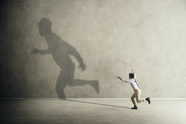 istock man trying to catch his shadow 862426818