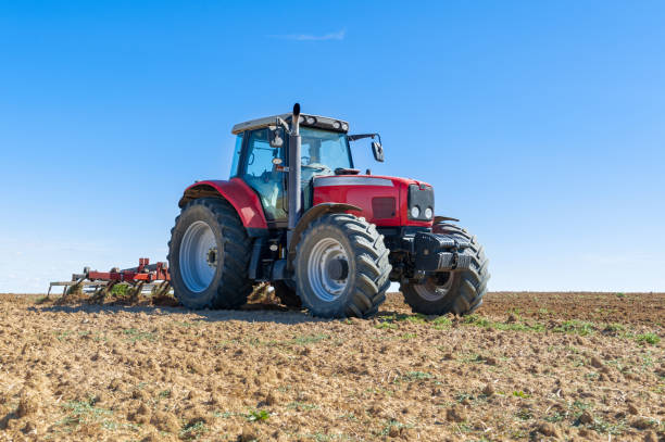 istock agricultural tractor in the foreground with blue sky background 862427156