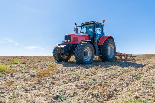 istock agricultural tractor in the foreground with blue sky background 862427292