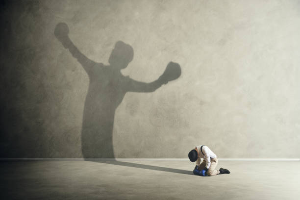 man defeated by his shadow boxing man defeated by his shadow boxing psyche stock pictures, royalty-free photos & images